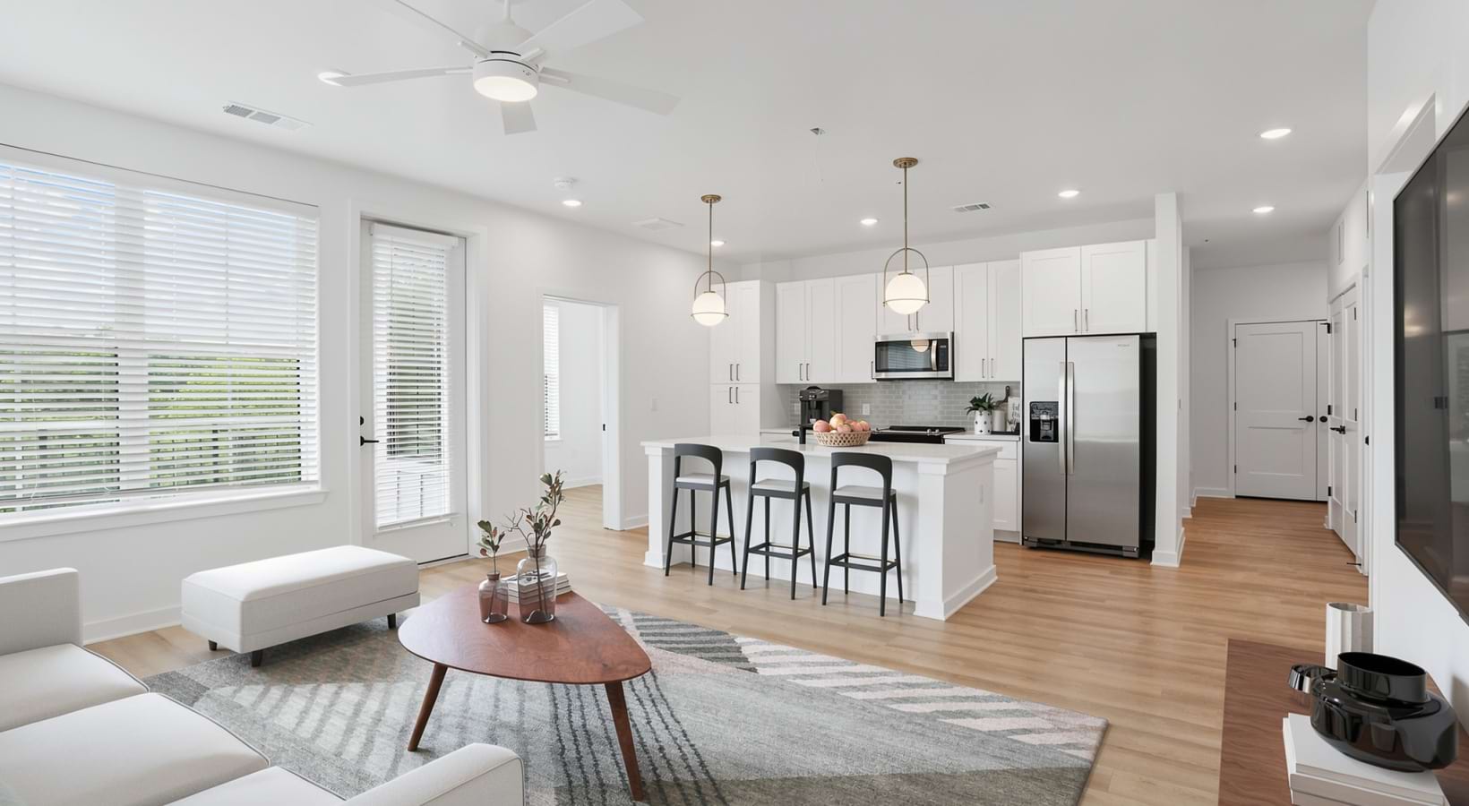 spacious and open living room leading into the kitchen